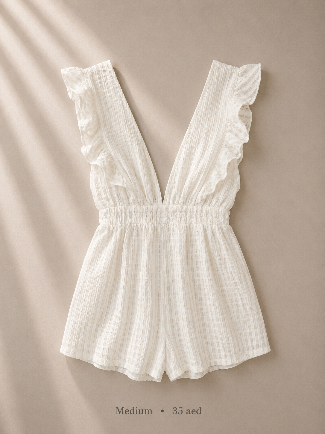 White ruffle flutter-sleeve romper with deep plunge V-neck and smocked waist, size Medium