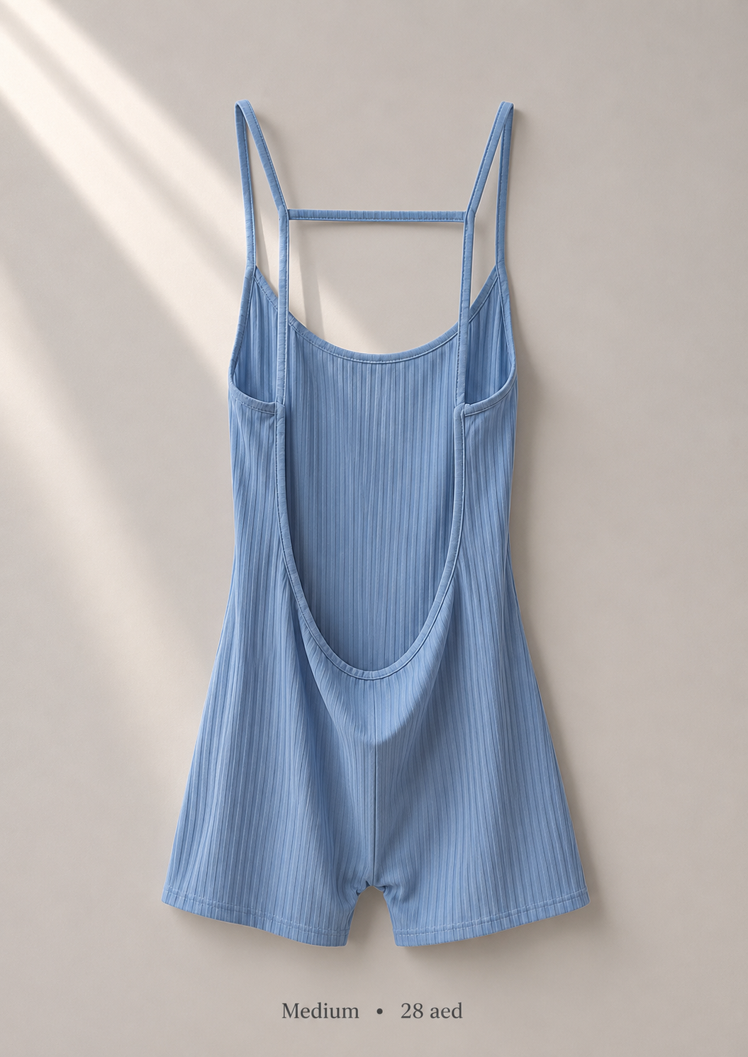 Ribbed powder blue cami romper with crossover open-back straps, size Medium — back view