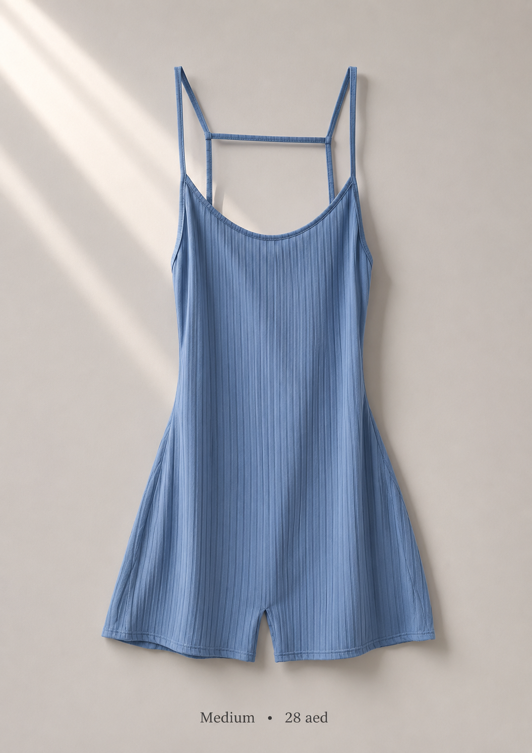 Ribbed powder blue cami romper with crossover open-back straps, size Medium — front view