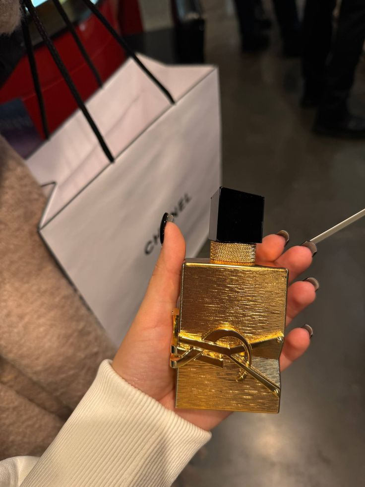 YSL Libre Vanille Couture bottle held in hand lifestyle shot