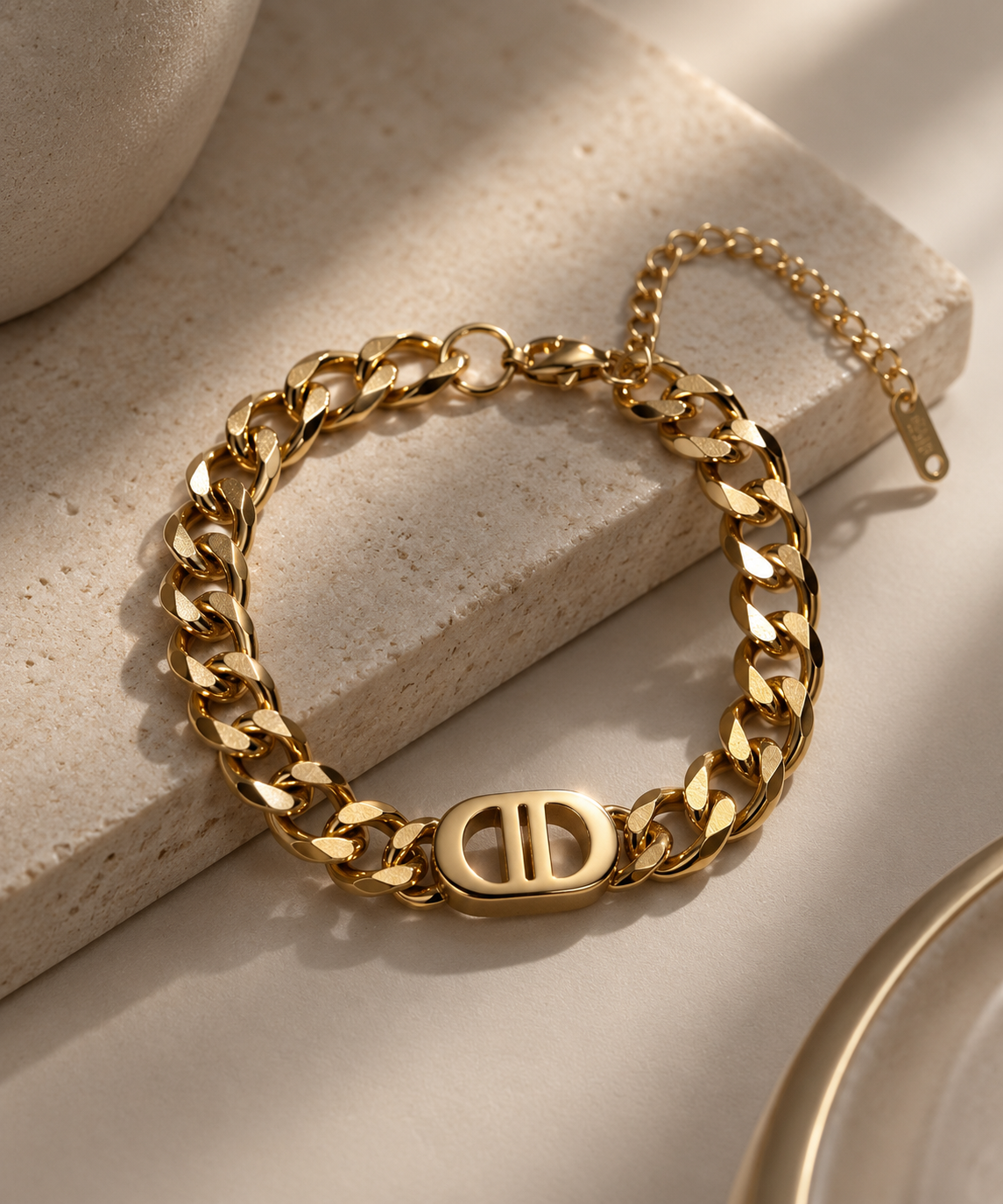 Gold chain bracelet with logo charm